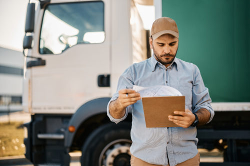 Truck driver going through paperwork before the ride.